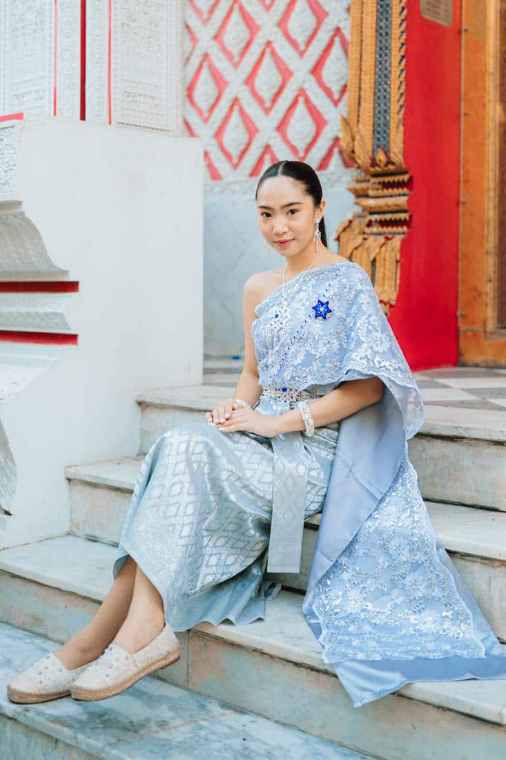 lady in thai costume sitting in the temple